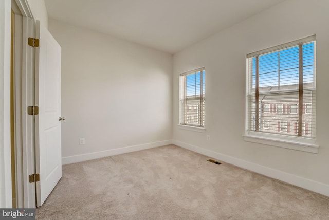 unfurnished room with light carpet