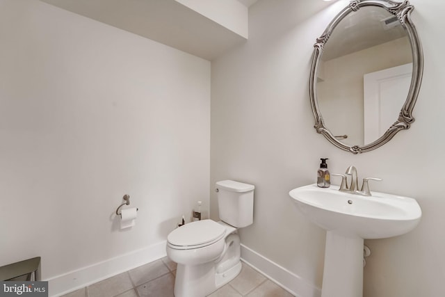 bathroom with sink, tile patterned floors, and toilet