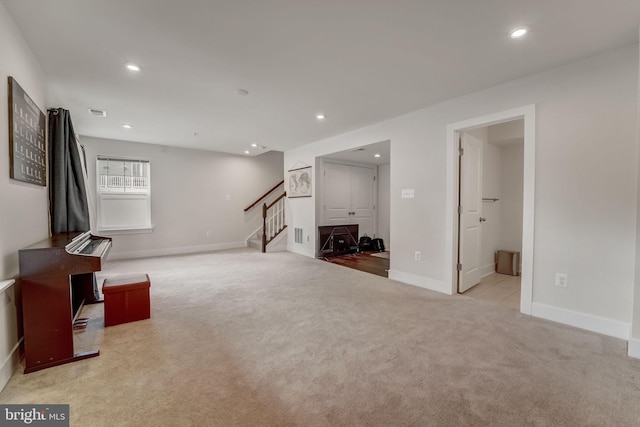 unfurnished living room featuring light colored carpet