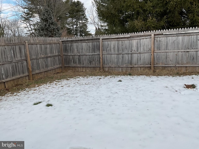 view of yard layered in snow