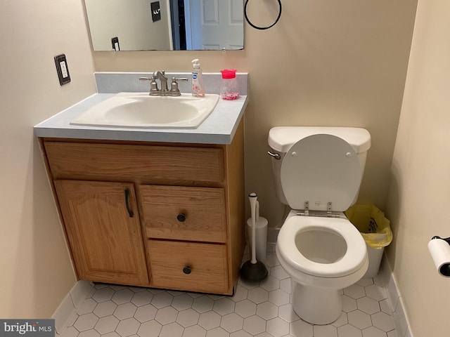 bathroom with tile patterned floors, vanity, and toilet