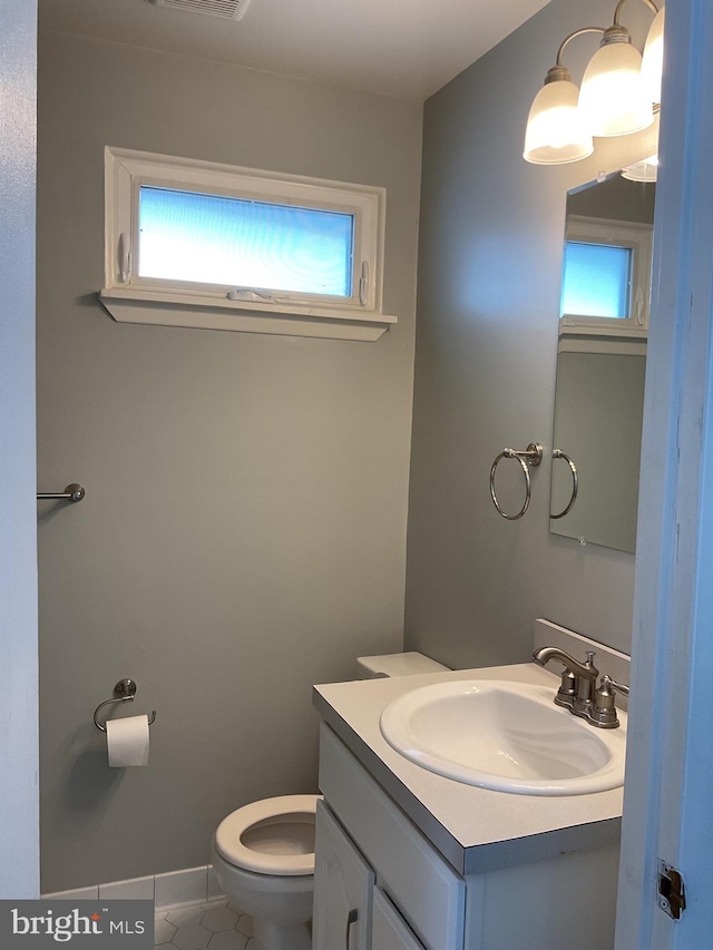 bathroom featuring vanity, toilet, and tile patterned flooring