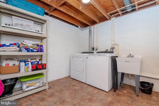 laundry room with sink and separate washer and dryer