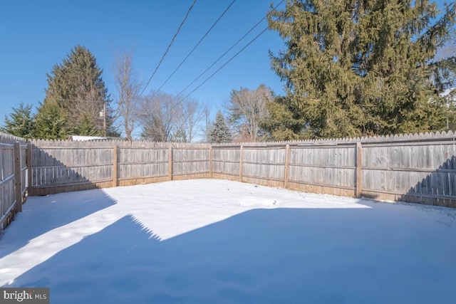 snowy yard with a patio area