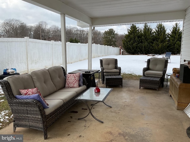 snow covered patio with outdoor lounge area