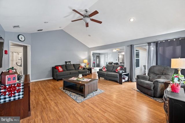 living room featuring ceiling fan, light hardwood / wood-style floors, and lofted ceiling