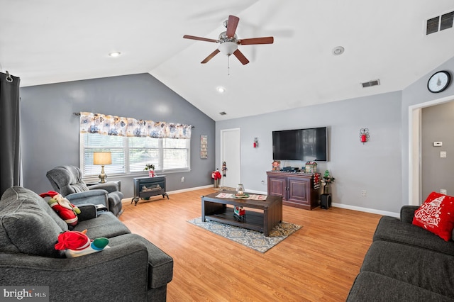 living room with hardwood / wood-style flooring, ceiling fan, and lofted ceiling