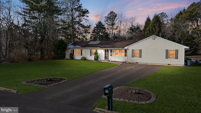 ranch-style home with a lawn