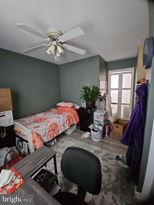 bedroom with french doors, ceiling fan, and hardwood / wood-style floors