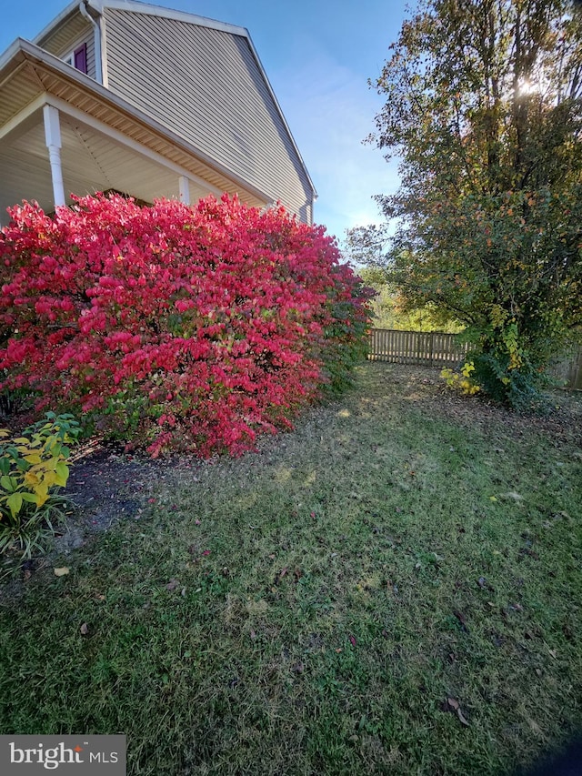 view of property exterior with a yard