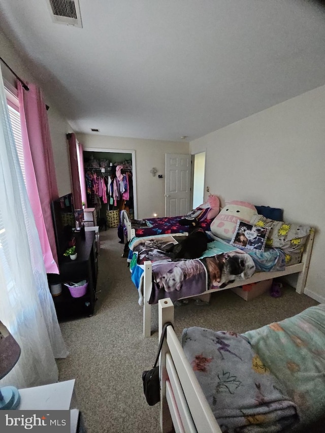 carpeted bedroom with a closet