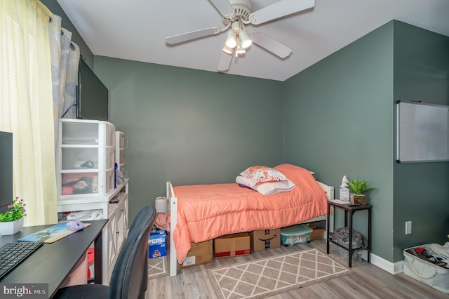 bedroom with ceiling fan and light wood-type flooring