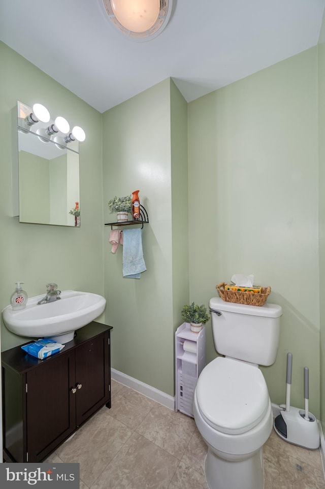 bathroom with vanity, toilet, and tile patterned flooring