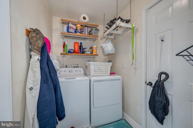 clothes washing area featuring separate washer and dryer