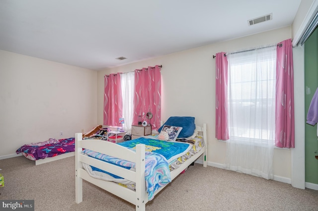 bedroom featuring light colored carpet