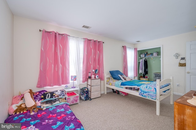 carpeted bedroom featuring a closet