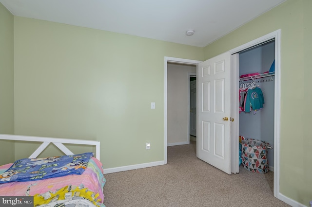 bedroom with light colored carpet and a closet