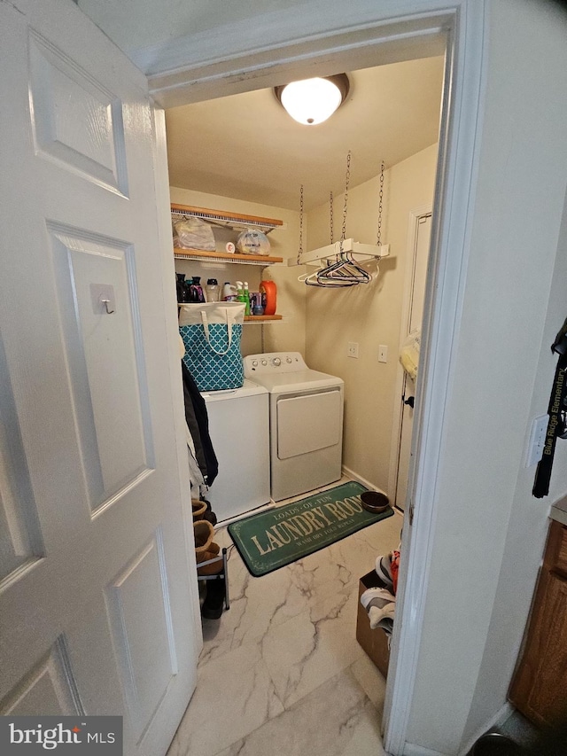 clothes washing area with washing machine and clothes dryer