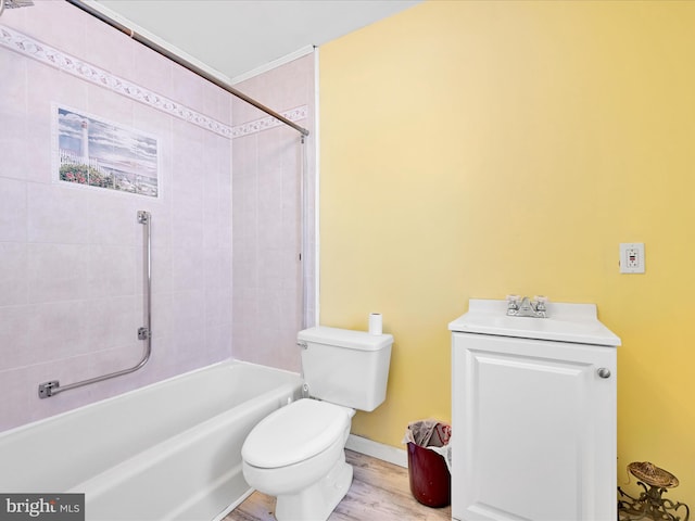 full bathroom with vanity, toilet, wood-type flooring, and tiled shower / bath