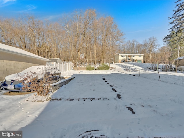 view of yard layered in snow