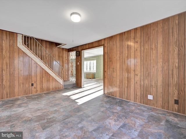 spare room featuring wooden walls