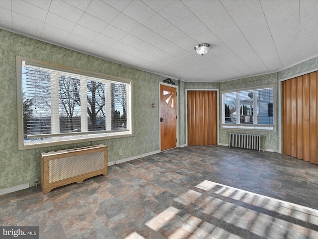 interior space with radiator heating unit and a healthy amount of sunlight