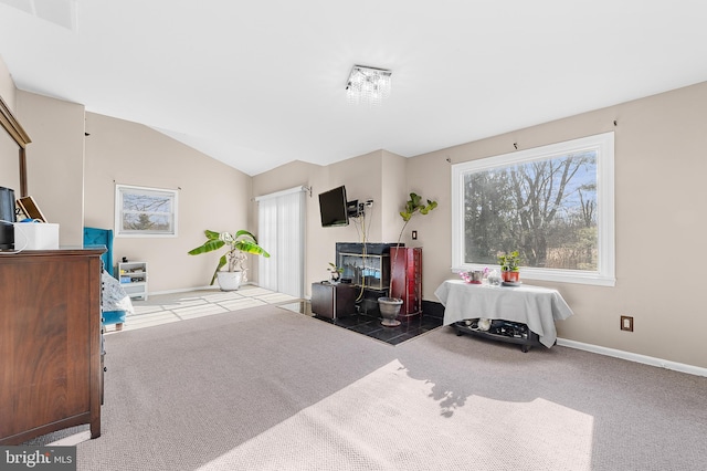 bedroom with vaulted ceiling and light colored carpet