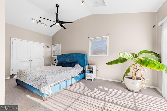 carpeted bedroom featuring ceiling fan, vaulted ceiling, and a closet