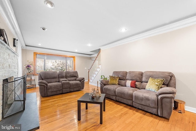 living room with ornamental molding and light hardwood / wood-style floors