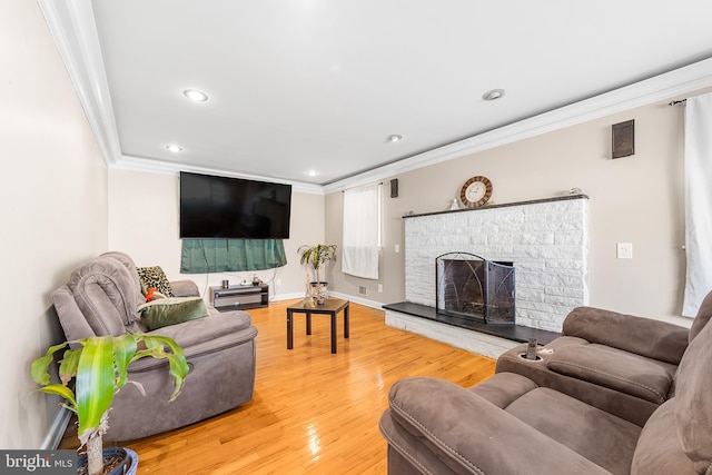 living room featuring crown molding and hardwood / wood-style flooring