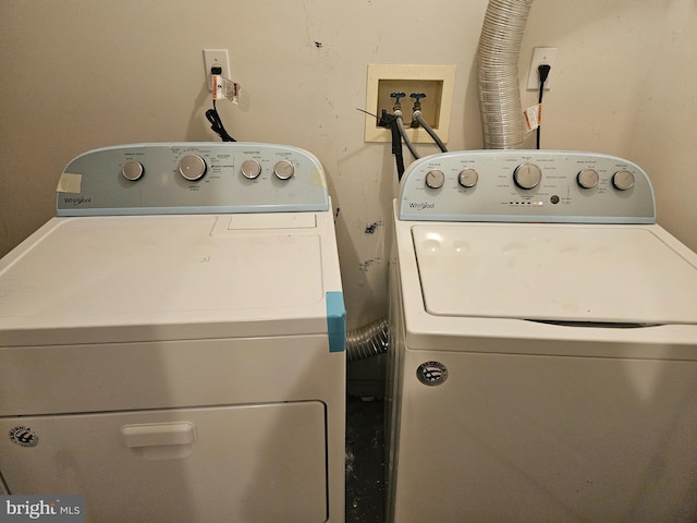 clothes washing area with washer and dryer