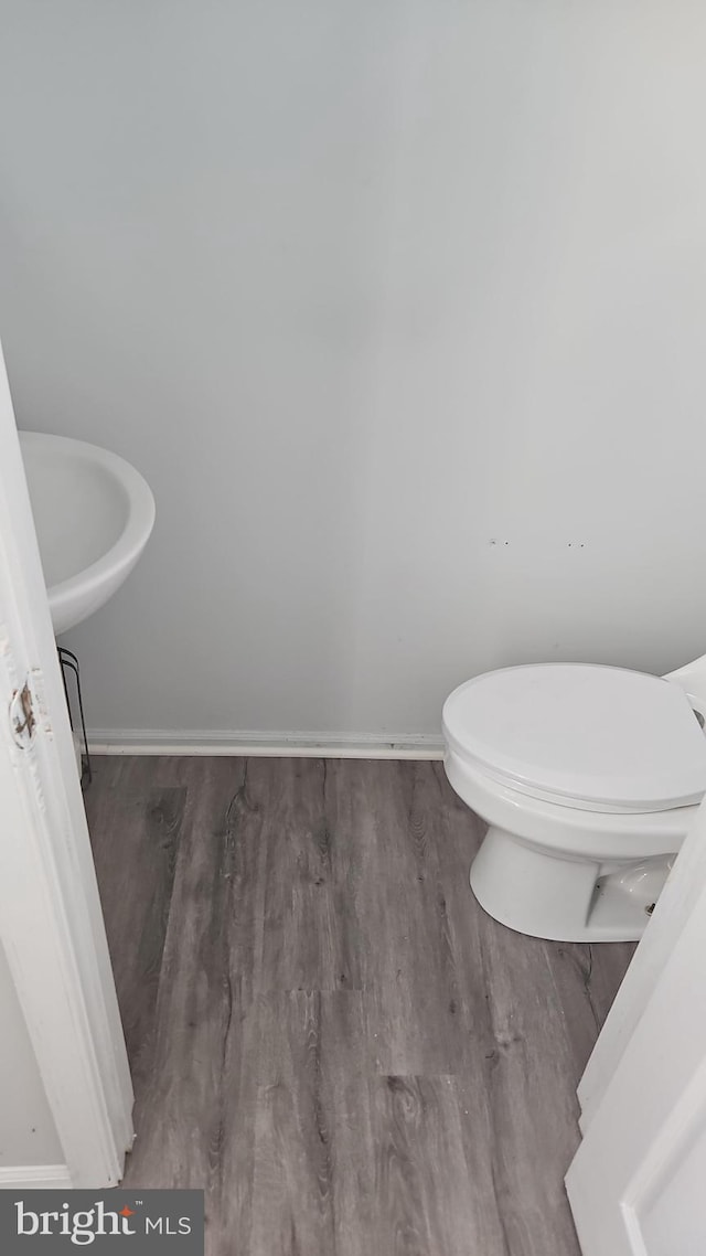 bathroom with sink, hardwood / wood-style flooring, and toilet