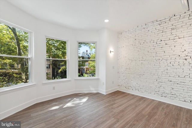 unfurnished room with hardwood / wood-style flooring