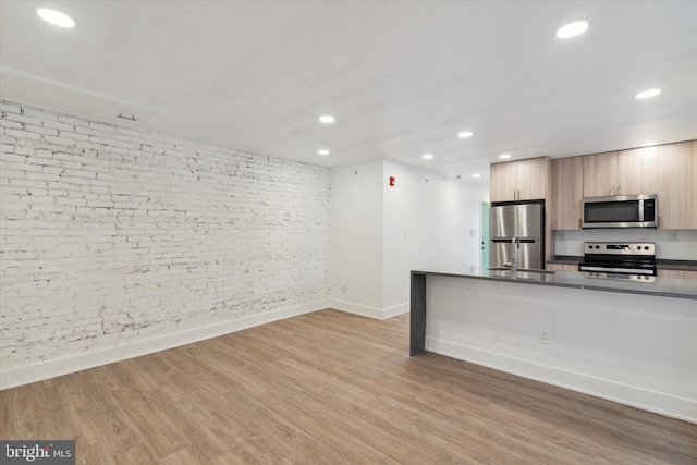 kitchen with appliances with stainless steel finishes and light wood-type flooring