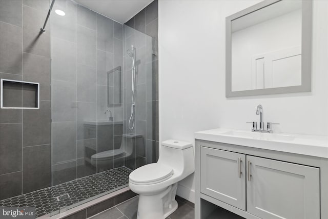 bathroom with walk in shower, tile patterned floors, vanity, and toilet