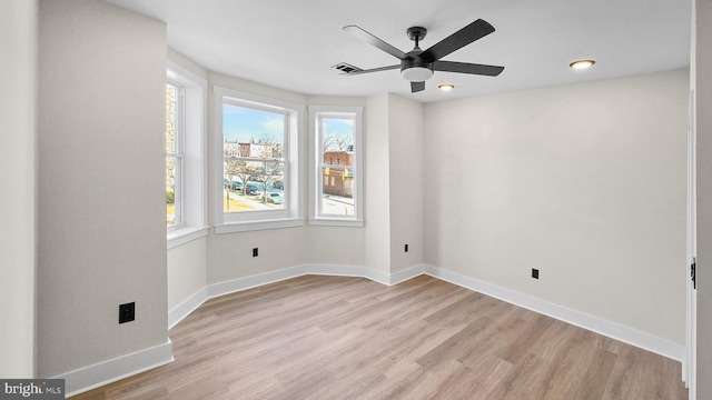 spare room with ceiling fan and light hardwood / wood-style floors