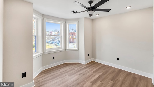 spare room featuring ceiling fan and light wood-type flooring