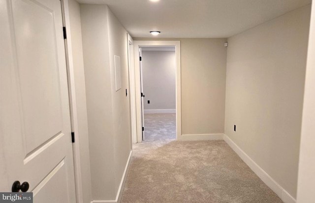 hall with light colored carpet