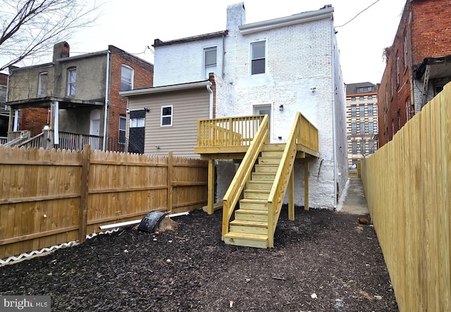 rear view of property featuring a deck