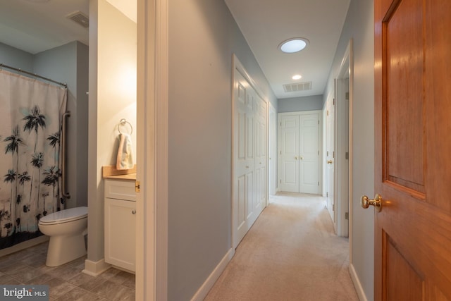 corridor with light colored carpet