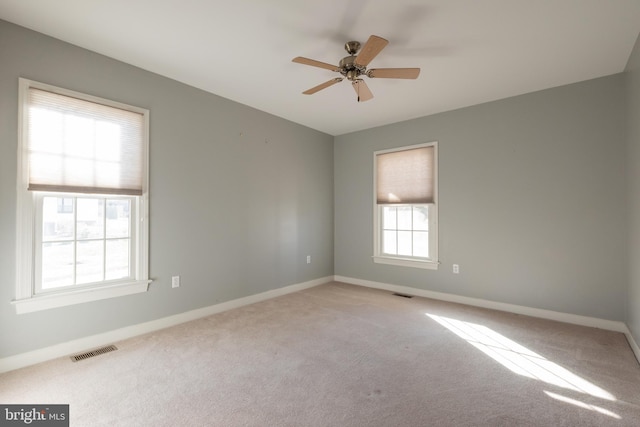 carpeted empty room featuring ceiling fan