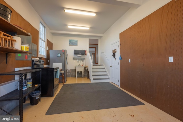 garage with stainless steel refrigerator