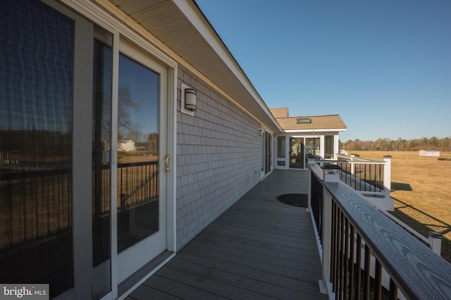 wooden terrace with a yard