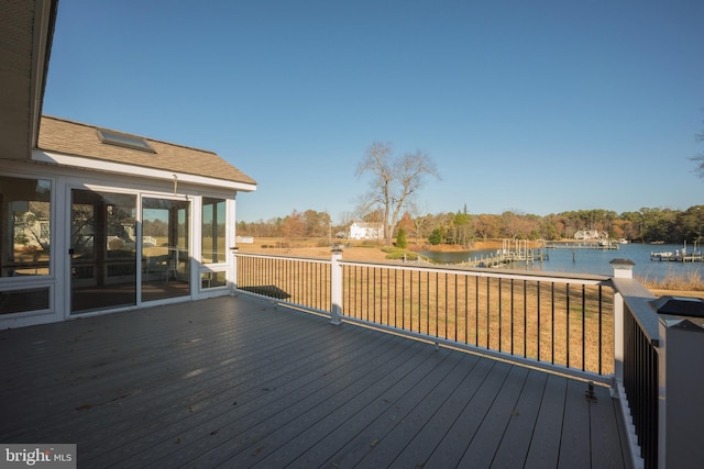 deck featuring a water view and a sunroom