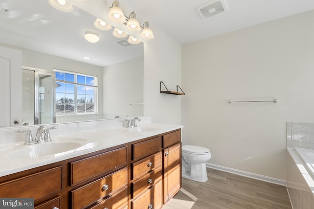 full bathroom with toilet, wood-type flooring, vanity, and plus walk in shower