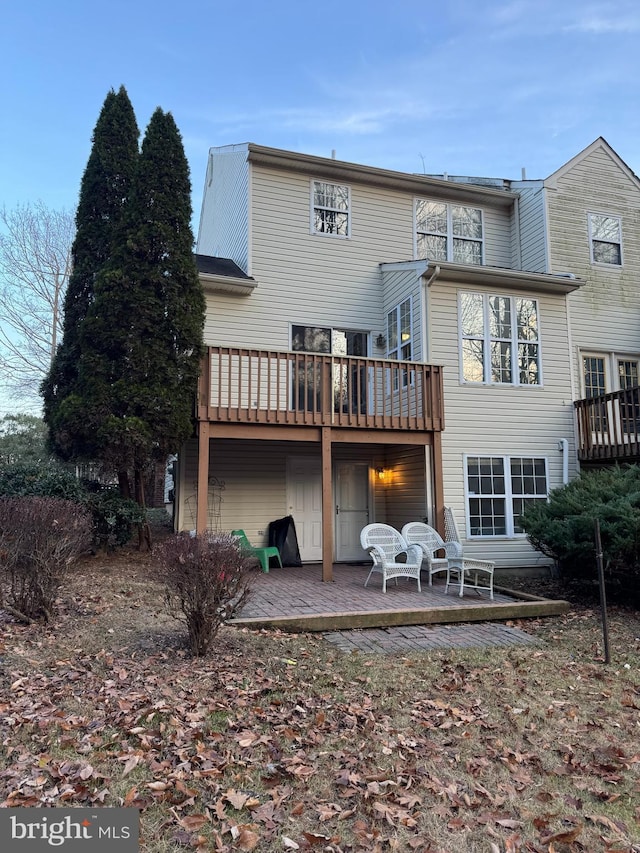 rear view of house featuring a deck