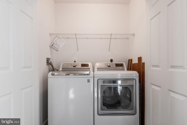 clothes washing area featuring washer and dryer