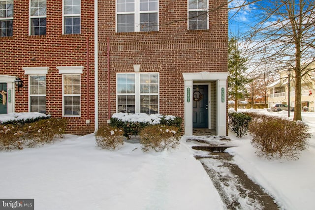 view of snow covered property entrance