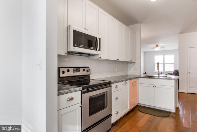 kitchen featuring ceiling fan, sink, stainless steel range with electric cooktop, kitchen peninsula, and white cabinets