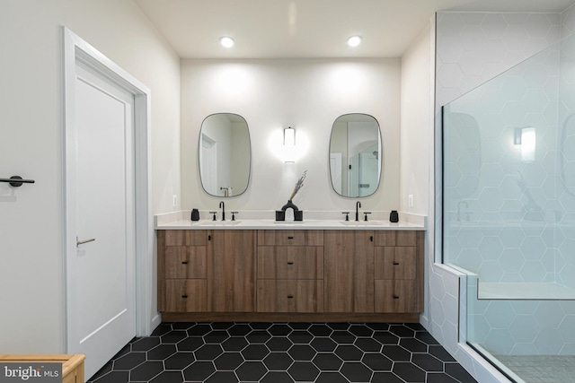 bathroom with vanity, a shower with shower door, and tile patterned flooring